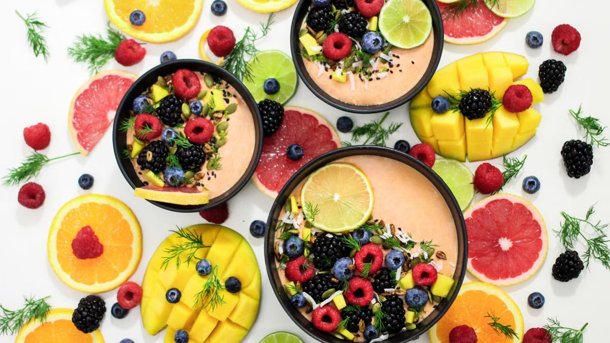 A colorful assortment of fresh fruit bowls featuring mixed berries and citrus slices, perfect for healthy eating inspiration.