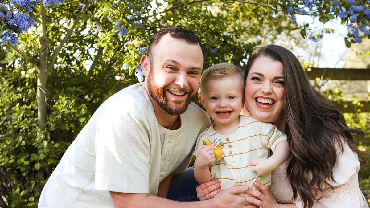 a man and a woman are holding a baby